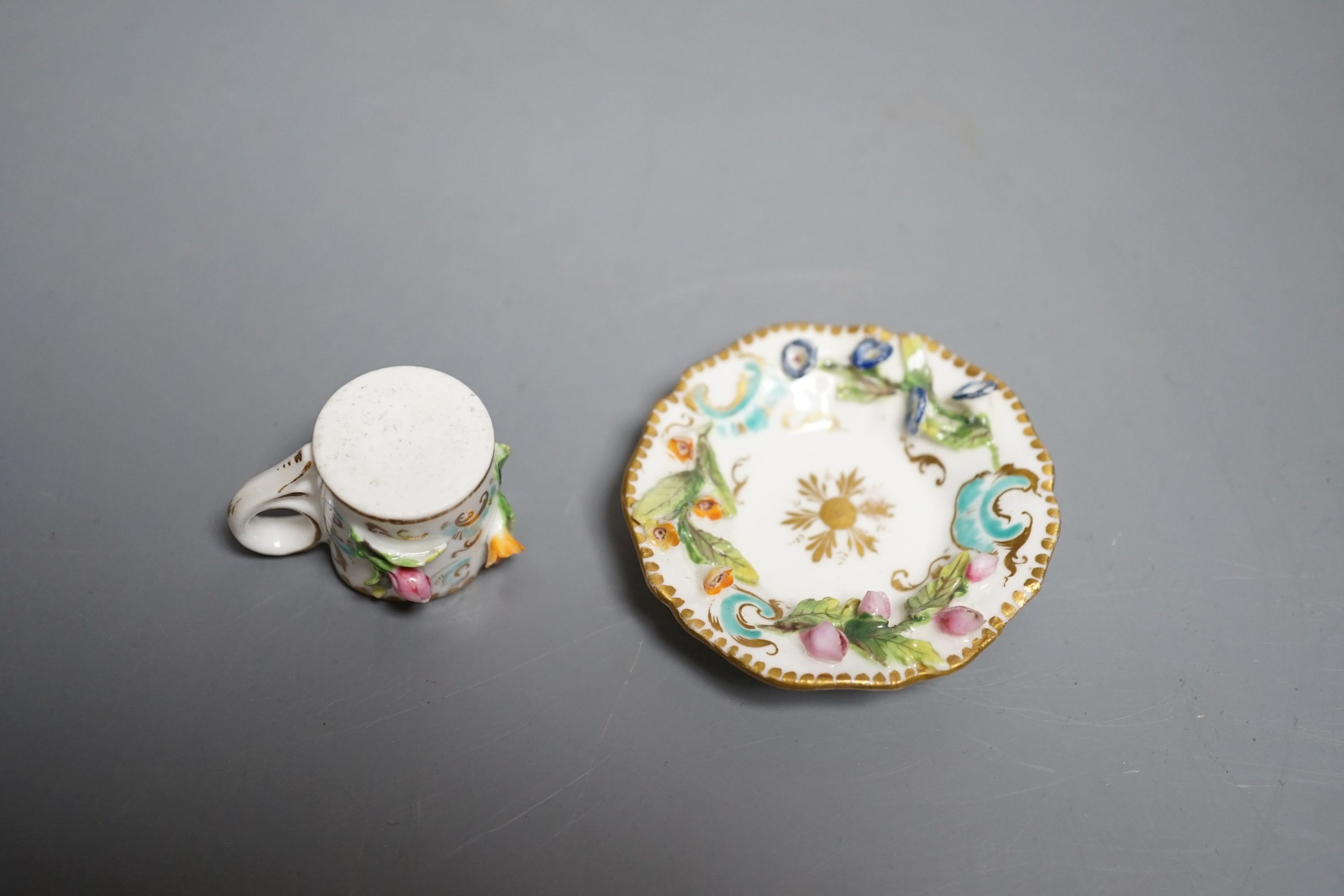 A Coalbrookdale miniature flower encrusted cup and saucer, c.1820. Provenance - Mona Sattin collection of miniature cups and saucers, collection no. 194.